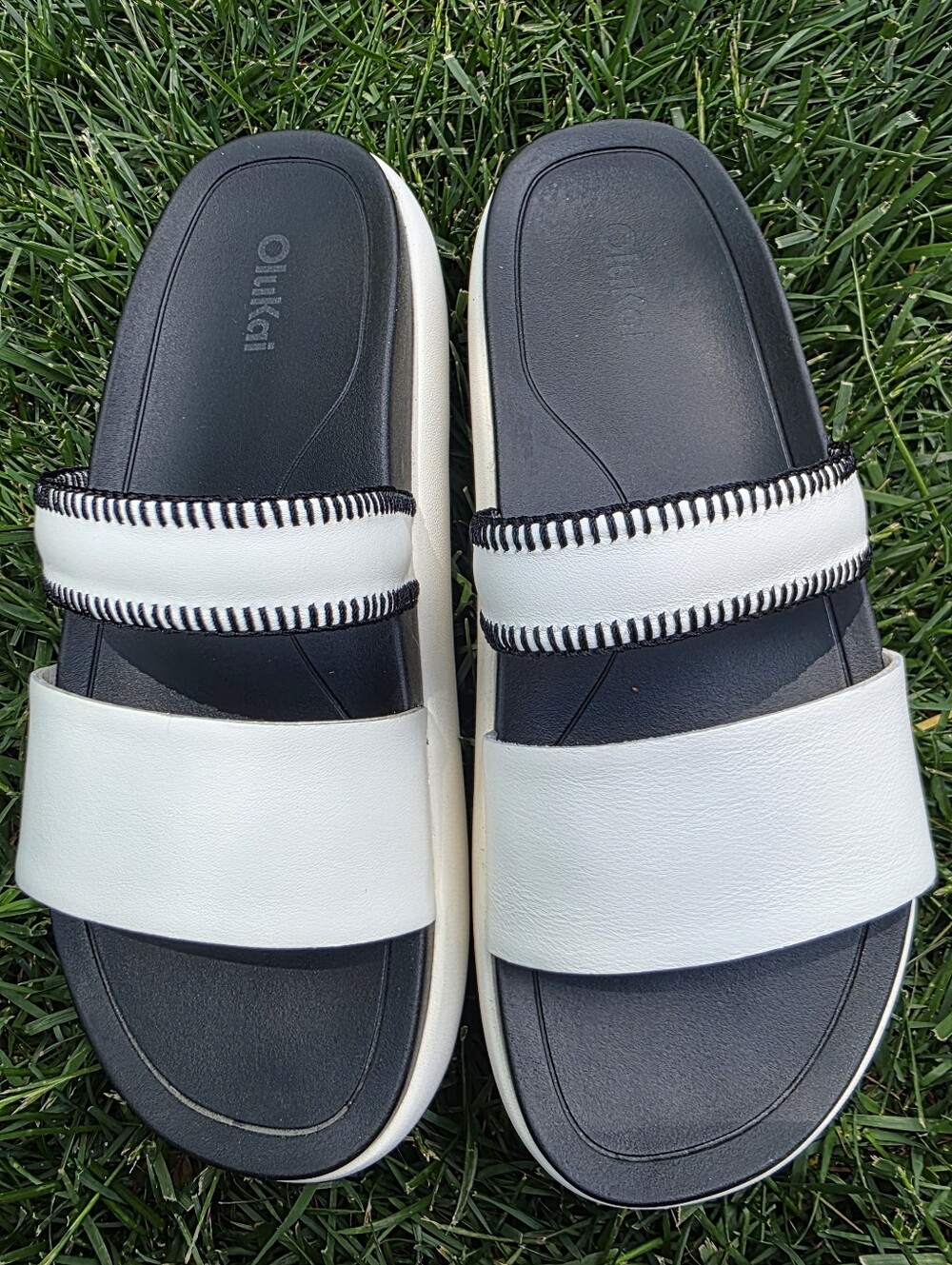 OluKai White and Black Two-Stripe Slide Sandals
